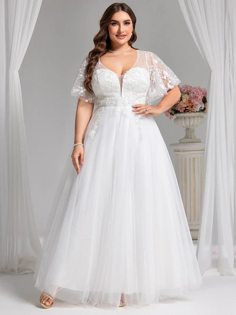 White plus size wedding dress with lace short sleeves and tulle skirt.