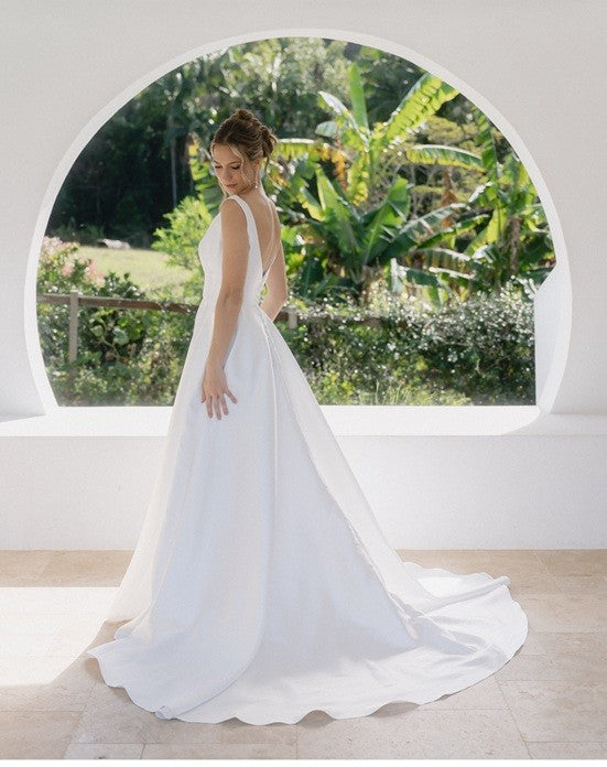 White plus size wedding dress in mikado satin with long train.