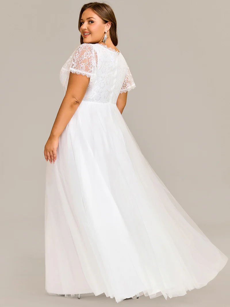 White plus size wedding dress with short sleeves and corset style front.