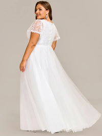 White plus size wedding dress with short sleeves and corset style front.