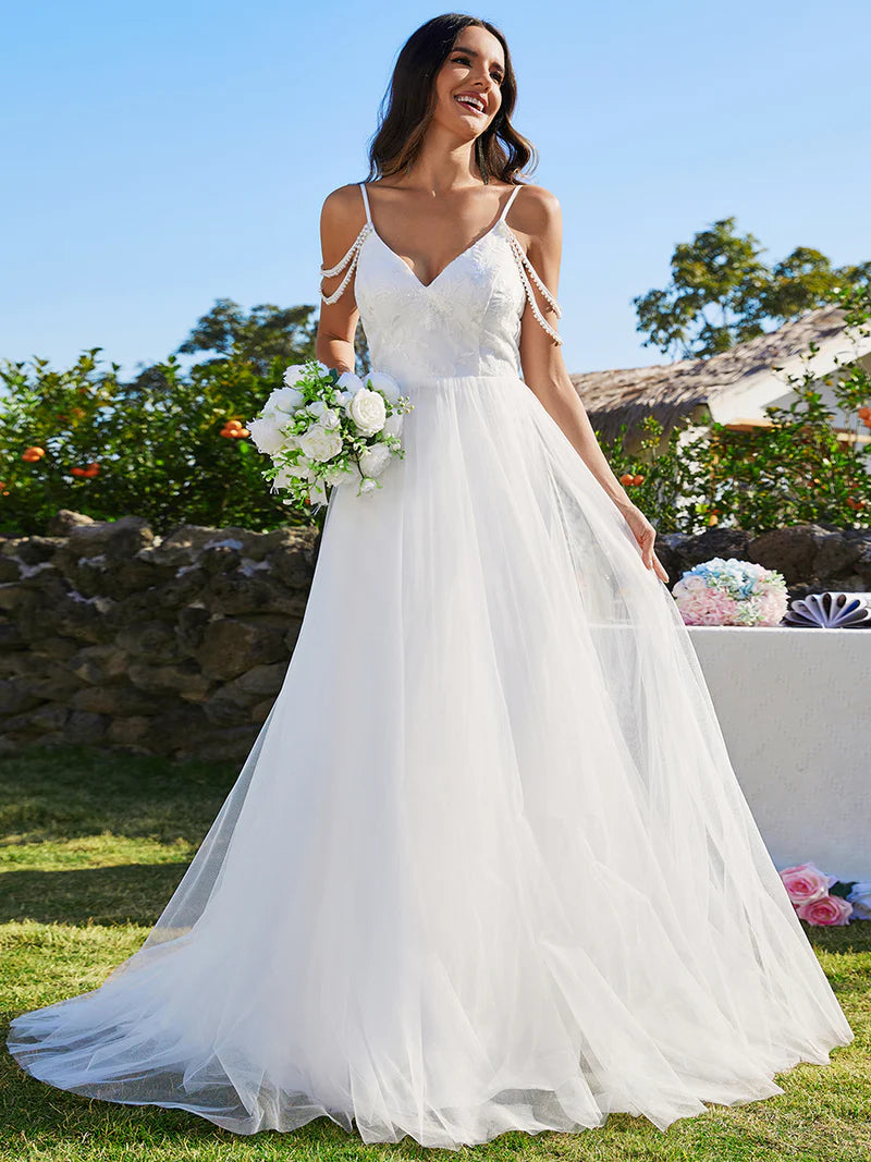 White wedding dress with pearl straps and tulle skirt.