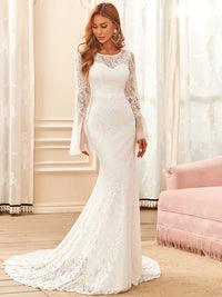 White wedding dress with round neck and long pagoda sleeves.