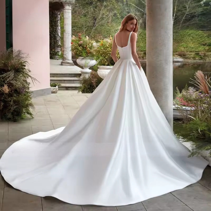 White or Ivory wedding dress with pockets in satin with square neck and train.