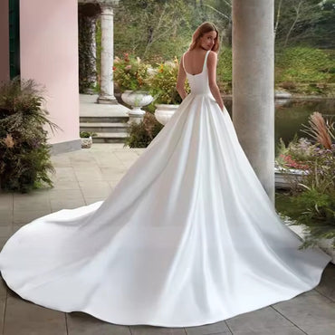 White or Ivory wedding dress with pockets in satin with square neck and train.