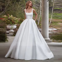 White or Ivory wedding dress with pockets in satin with square neck and train.