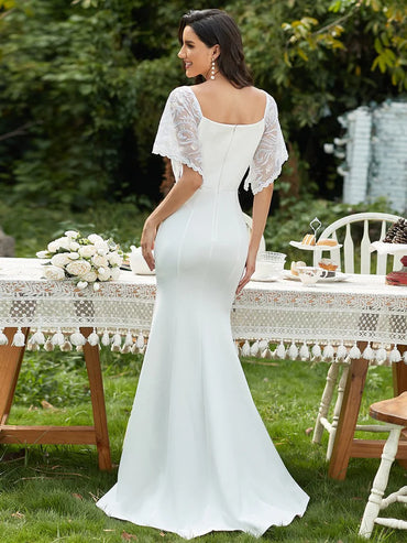 White wedding dress with v-neck, lace sleeves and fishtail.